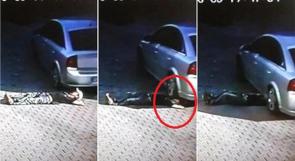بالفيديو .. ينجو من الموت رغم مرور السيارة فوق رأسه