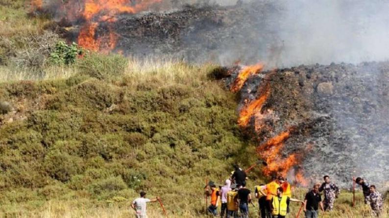 مستوطنون يضرمون النار في أراضي حوسان
